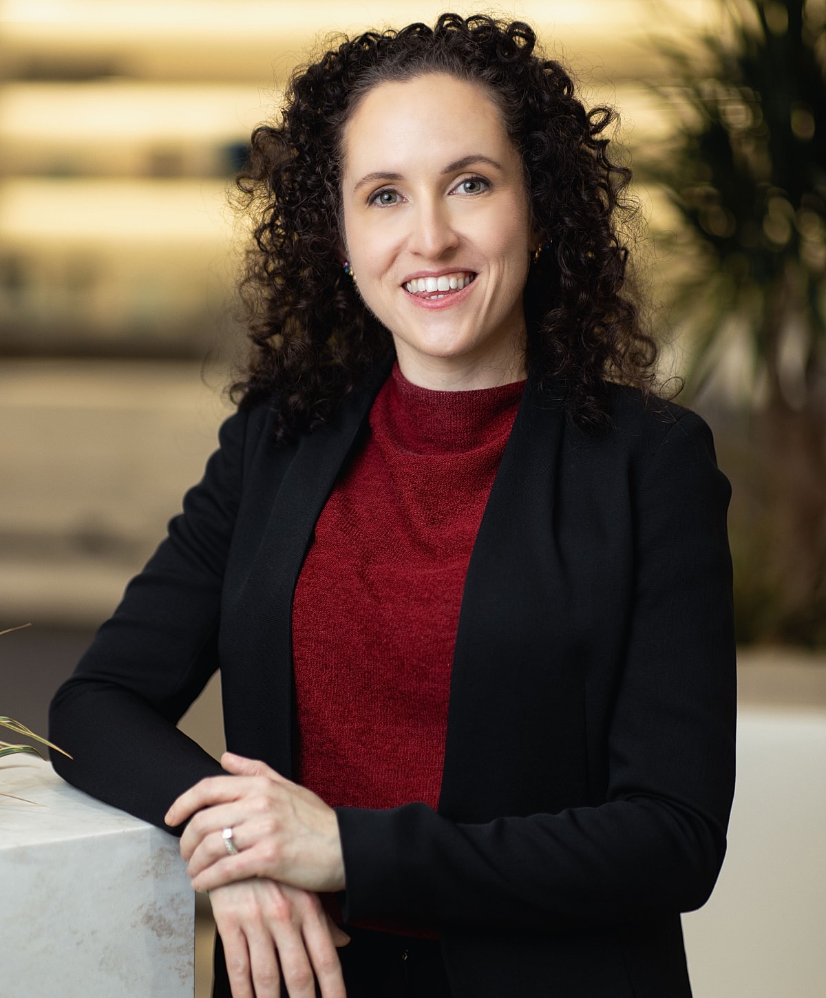 Dr. Alaina Garbens smiling in office setting.