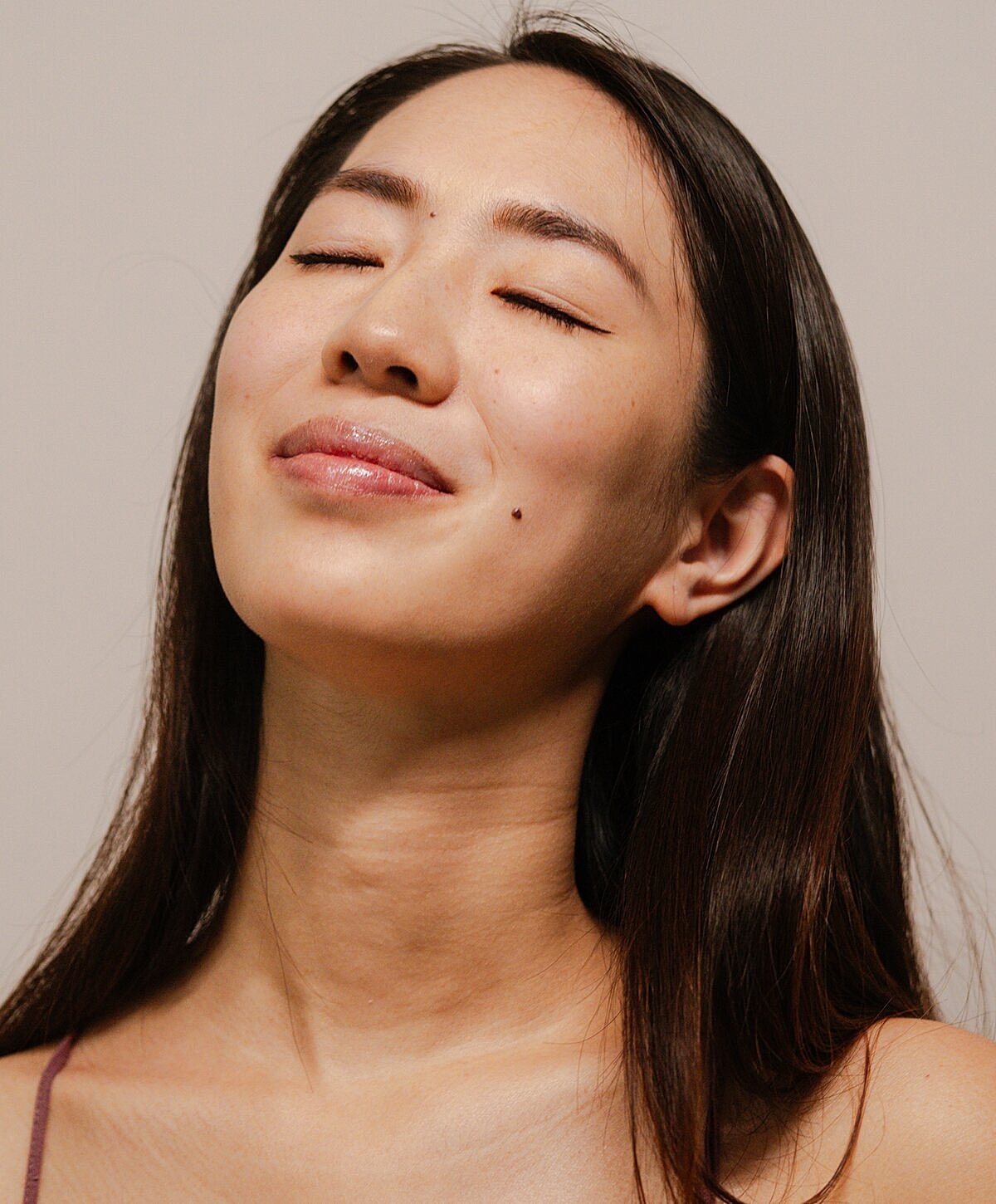 Woman with closed eyes, serene expression.