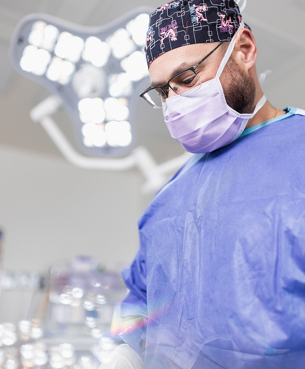 Surgeon preparing for a procedure in operating room.