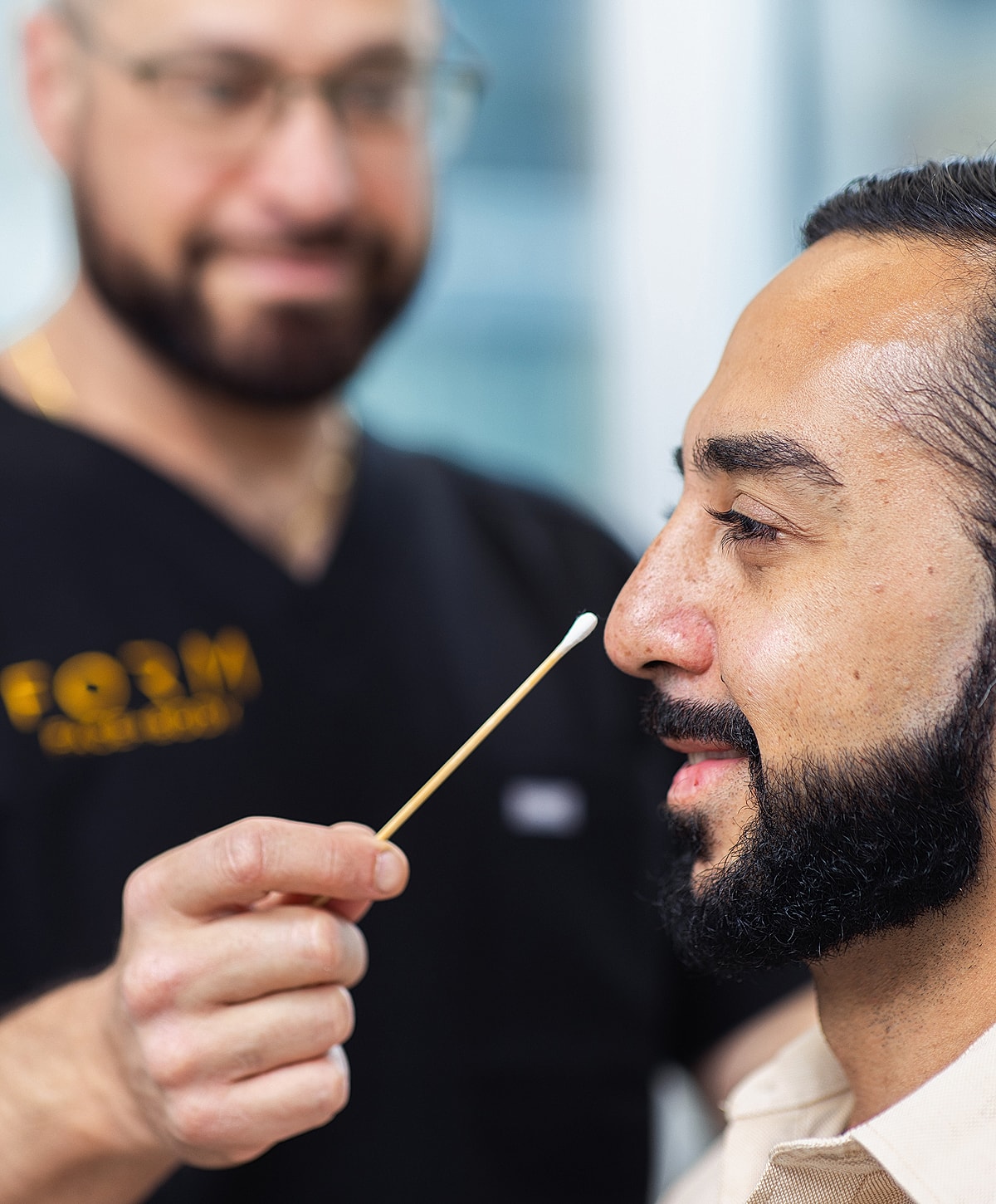 Patient receiving a nasal swab for testing.