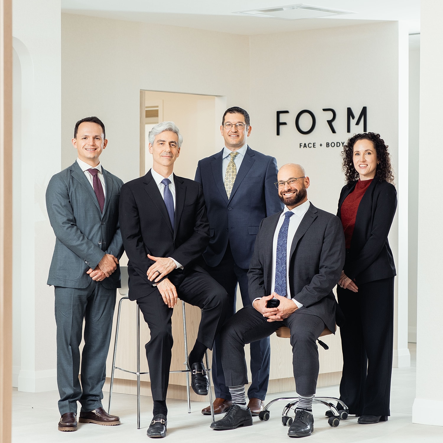 Medical professionals posing in office setting.