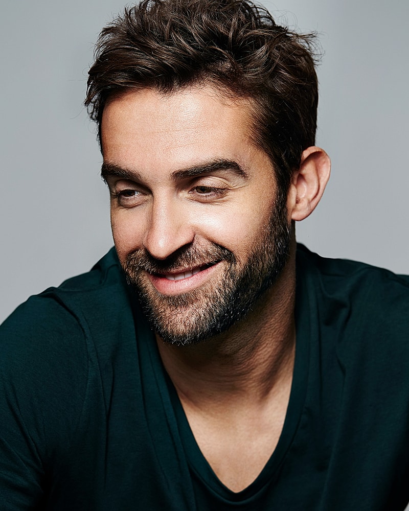 Smiling man with beard and tousled hair