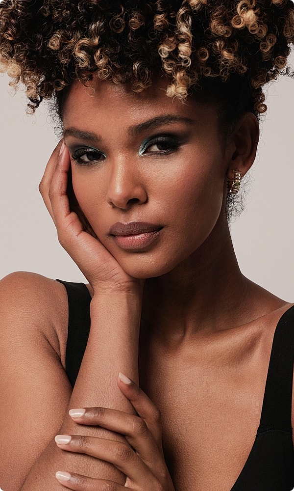 Portrait of a woman with curly hair.