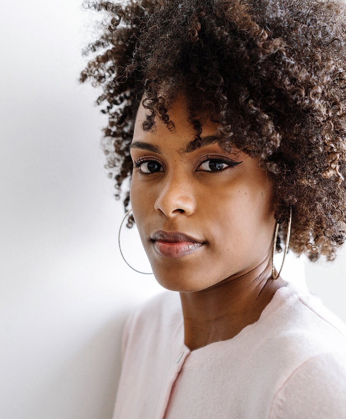 Close-up of a woman with curly hair.