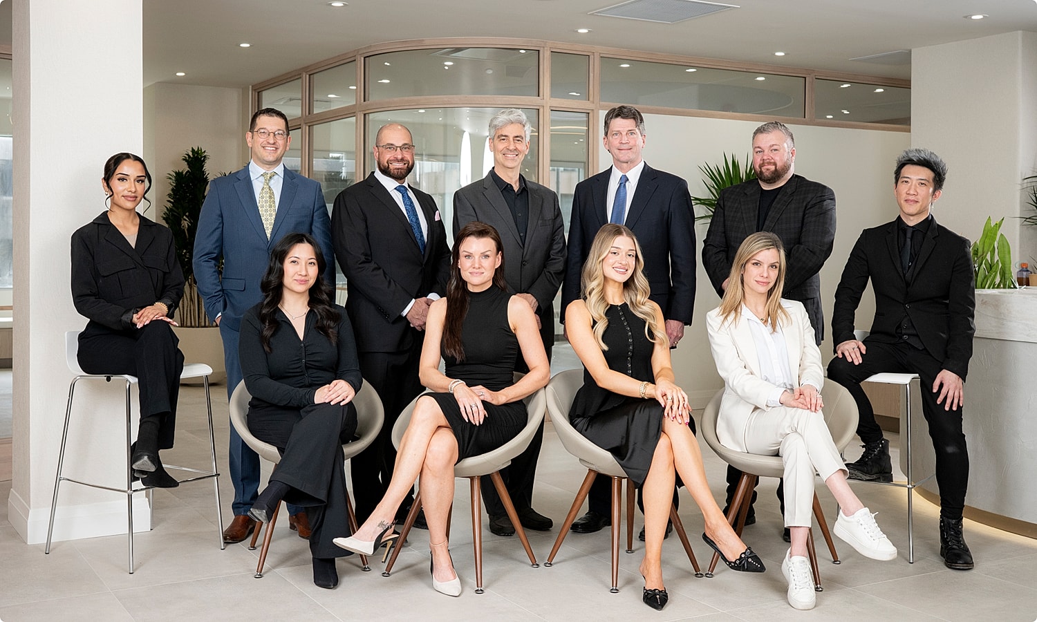 Professional team posing in modern office setting.