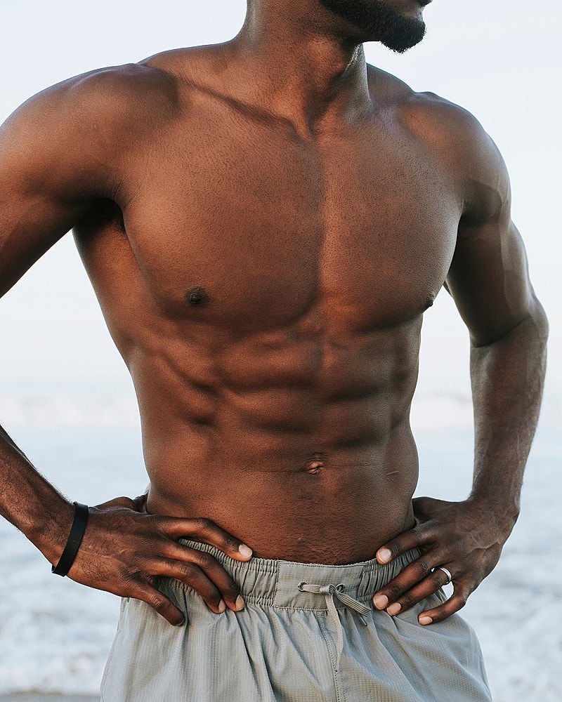 Man with athletic build at the beach.