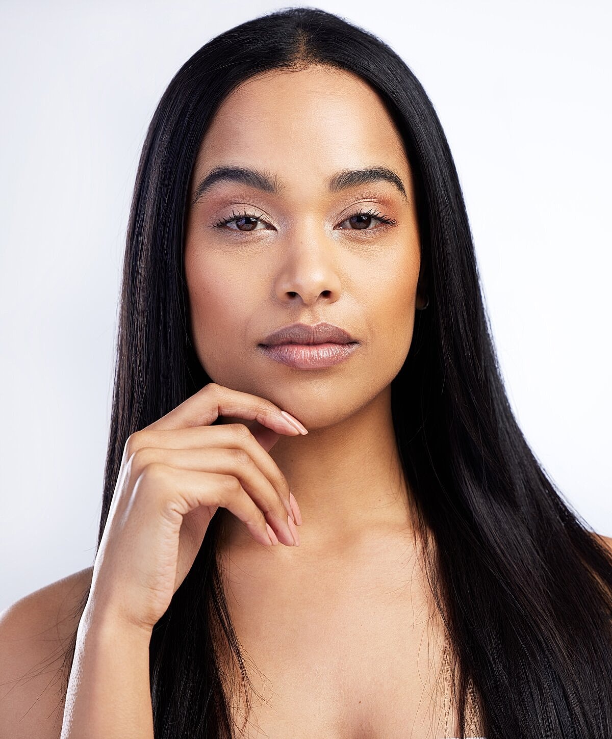 Young woman with long hair and natural makeup.