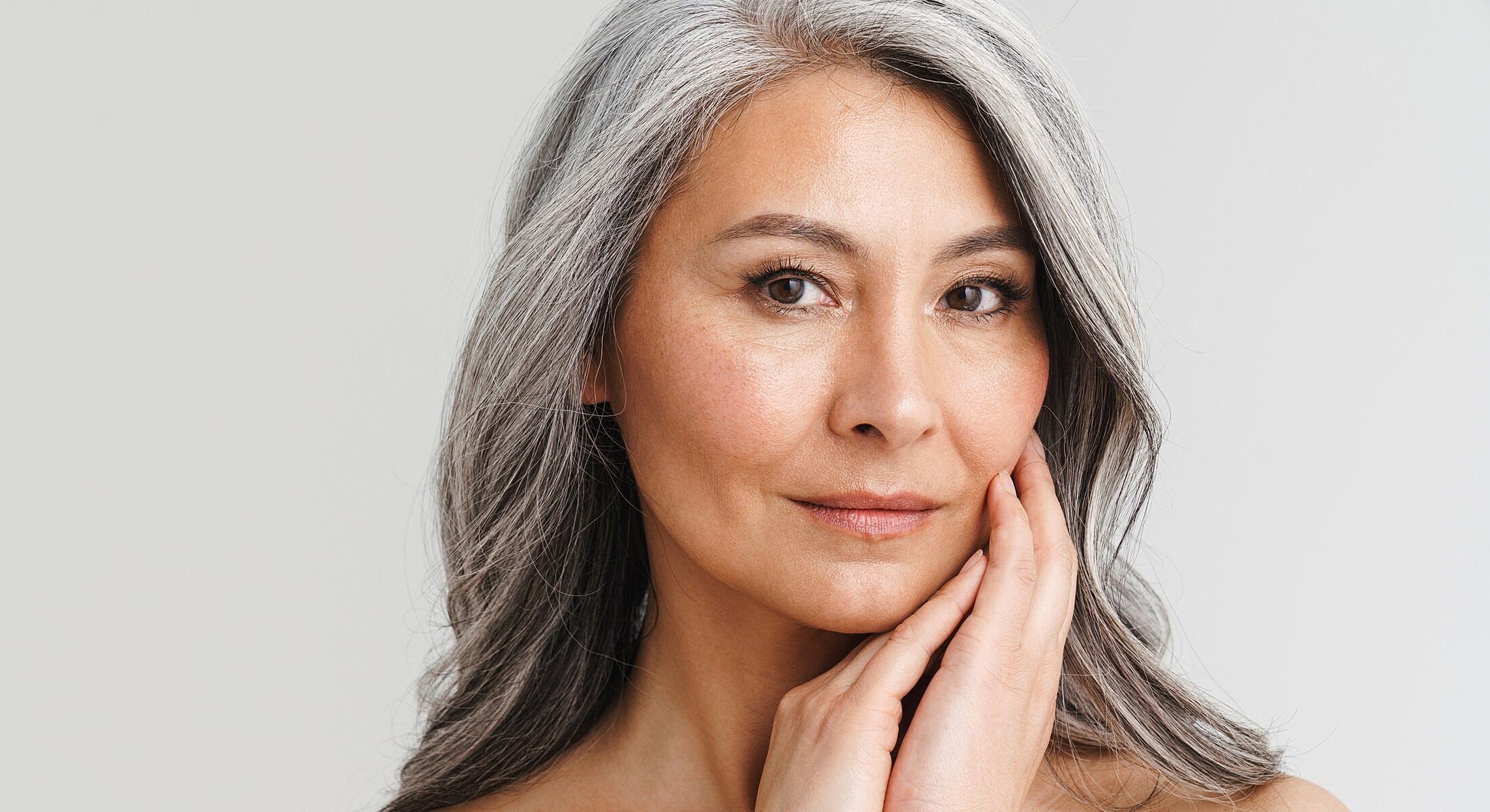 Gray-haired woman with a thoughtful expression.