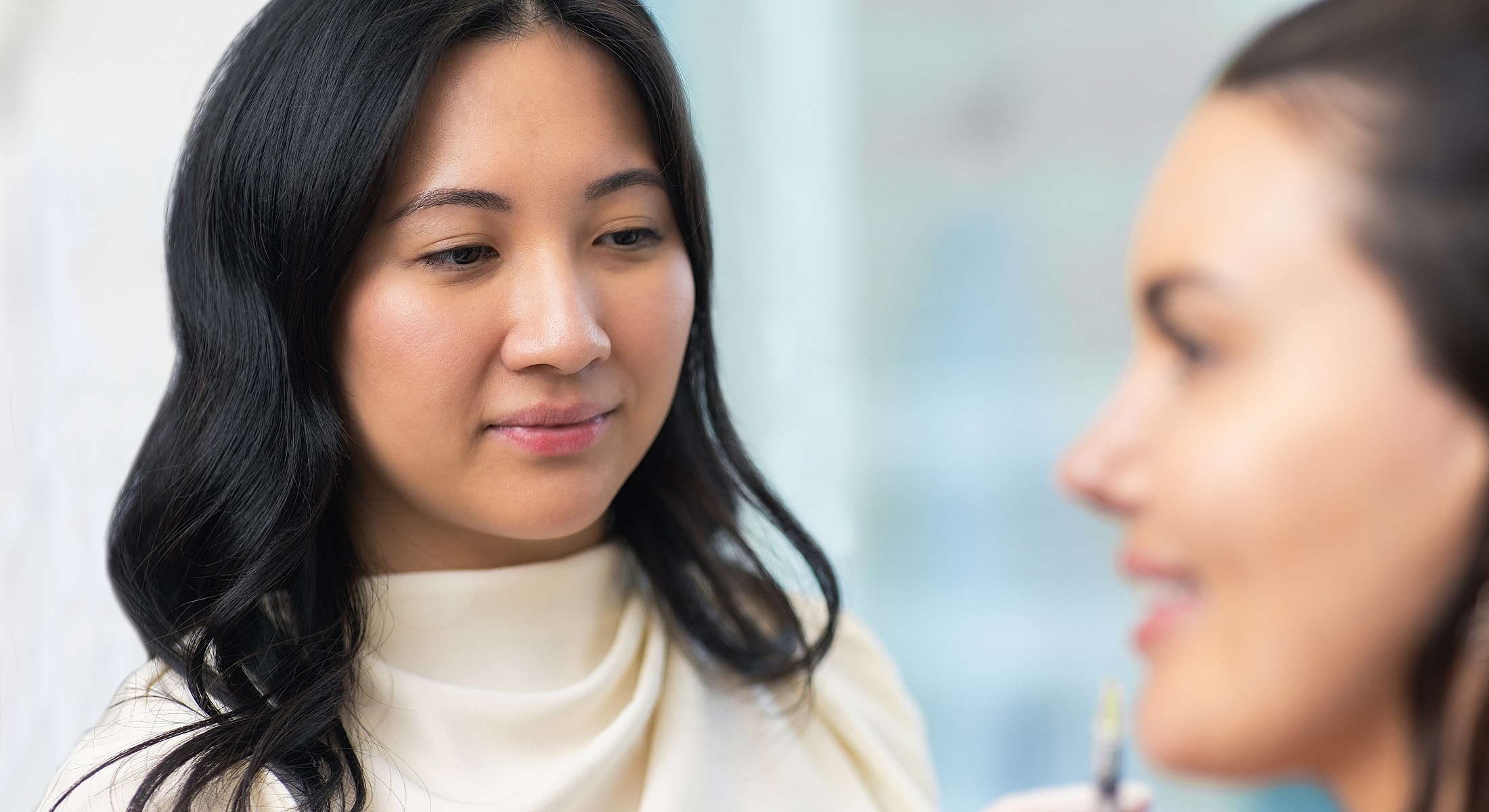 Two Toronto Botox models engaging in a beauty consultation.