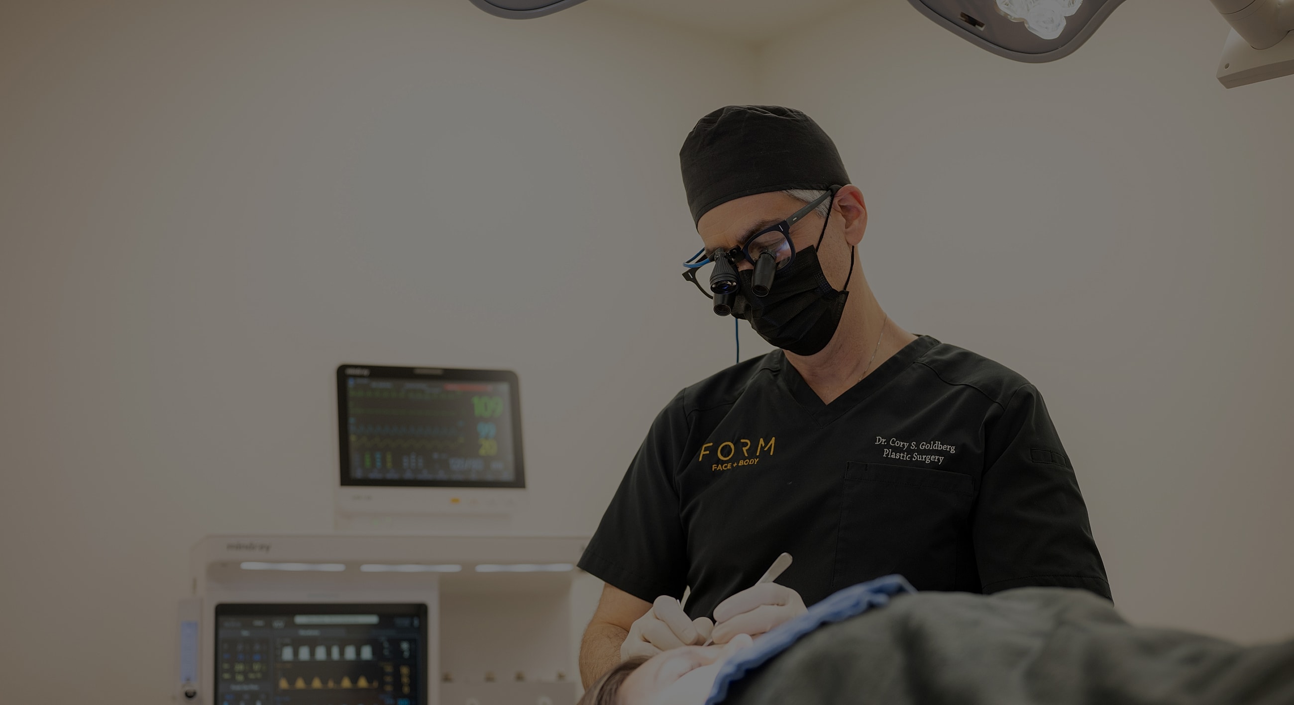 Surgeon performing procedure in operating room.