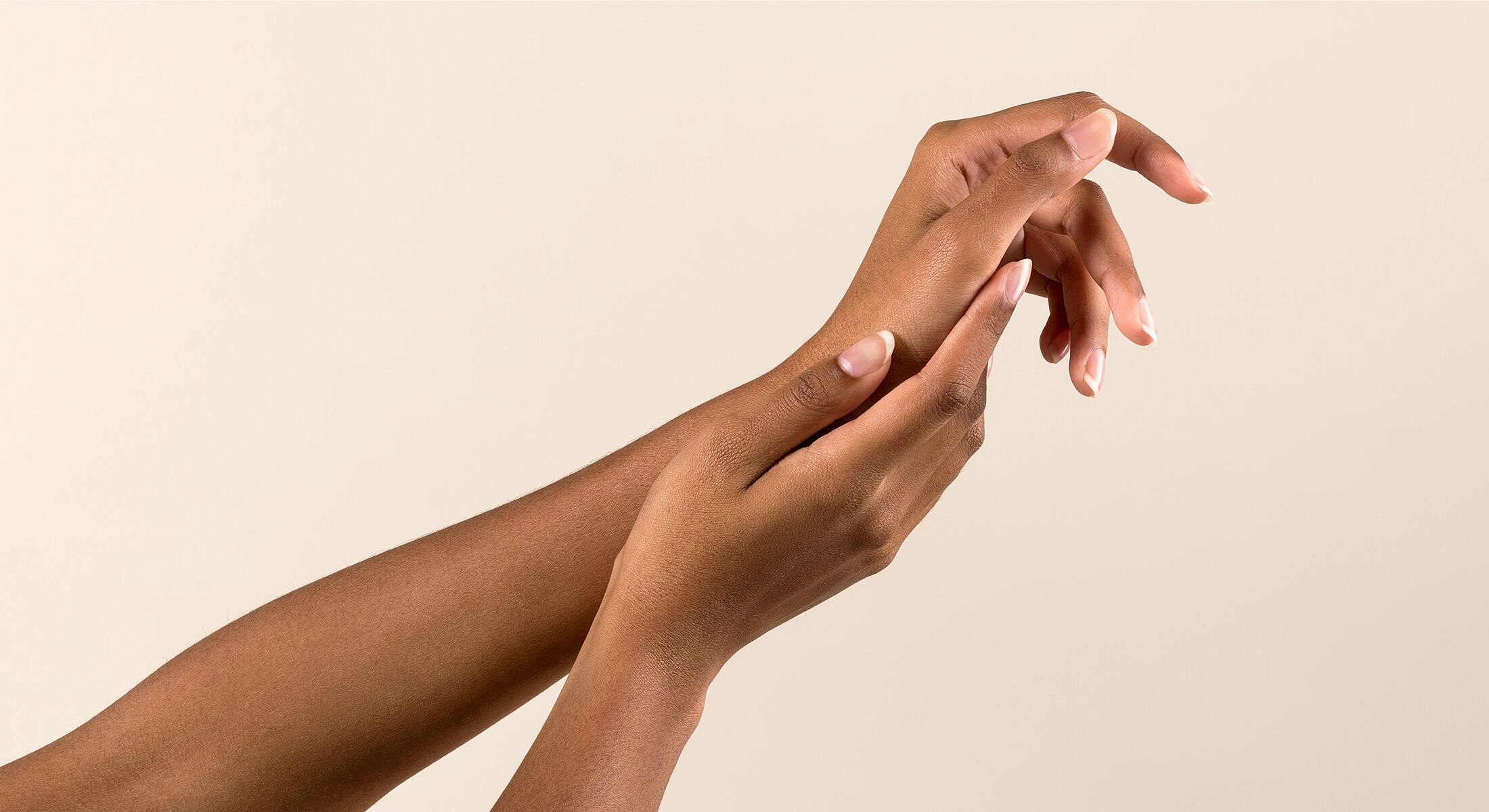 Two hands gently touching each other.