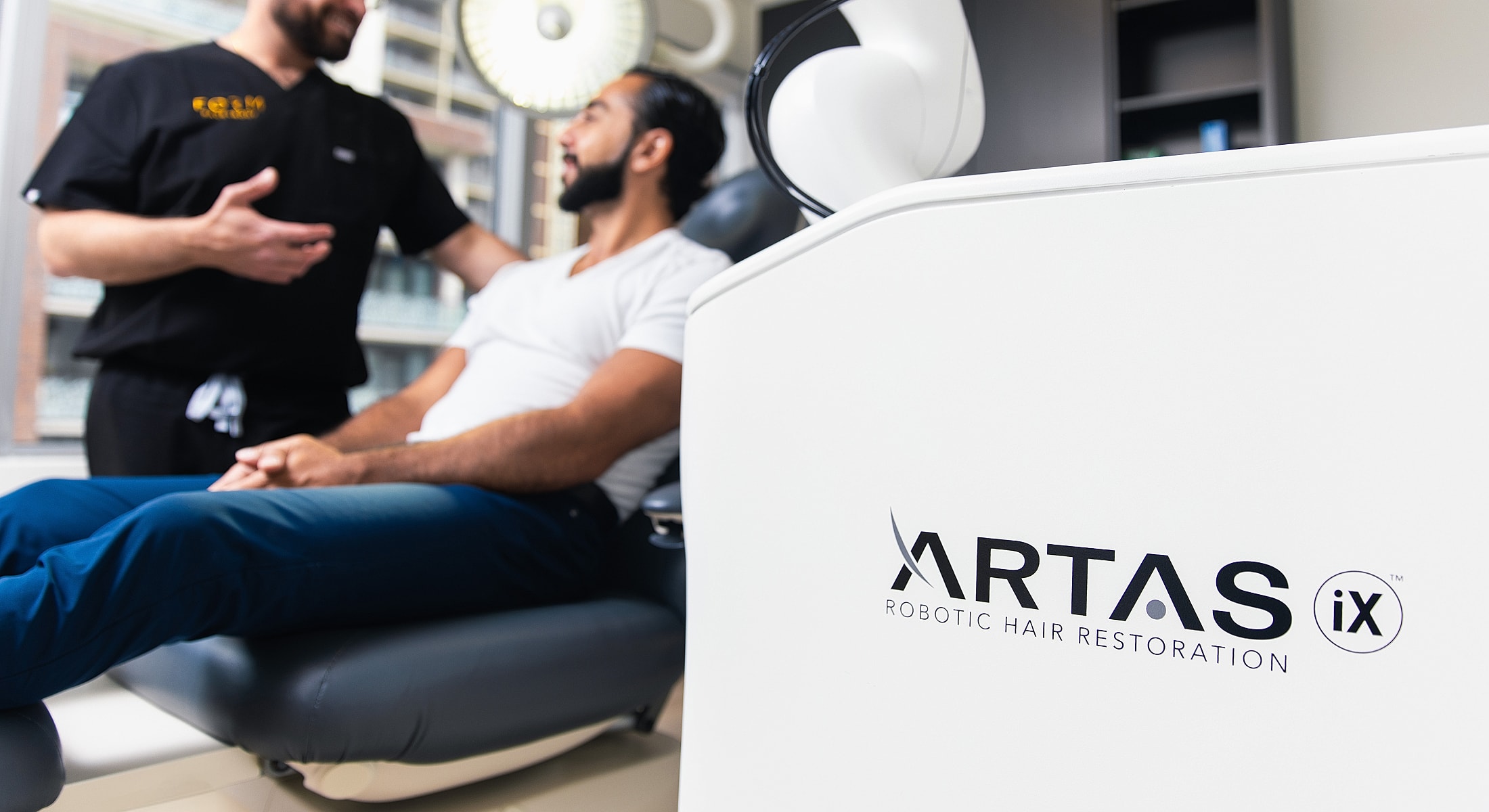 Robotic hair restoration consultation in clinic setting.