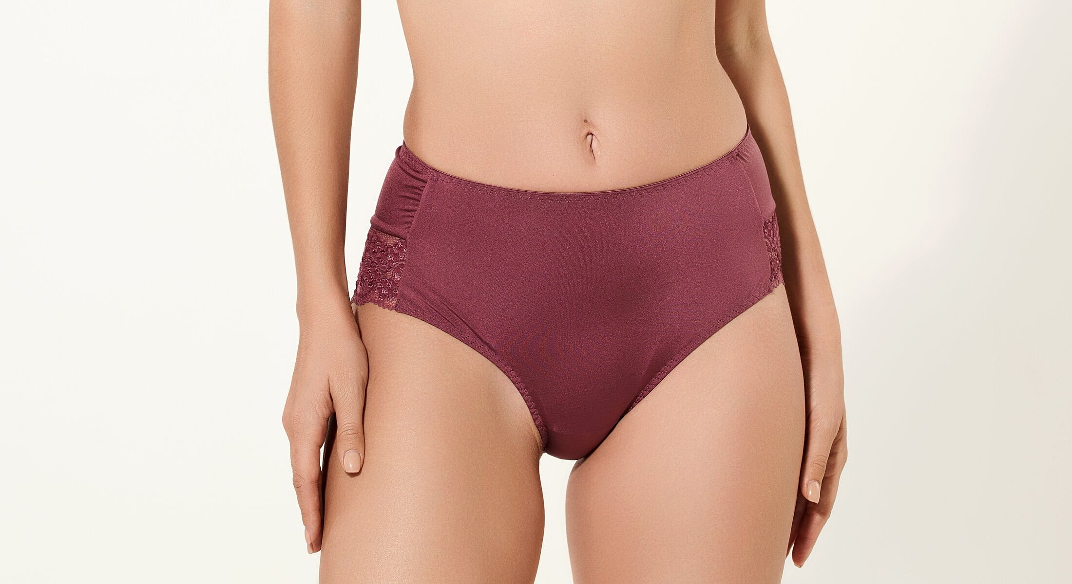 High-waisted burgundy women's underwear with lace detailing.